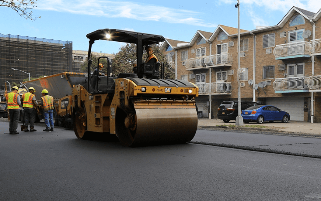 Work on city street; Protected Streets; Photo from https://www.nycstreetdesign.info/material/asphaltic-concrete