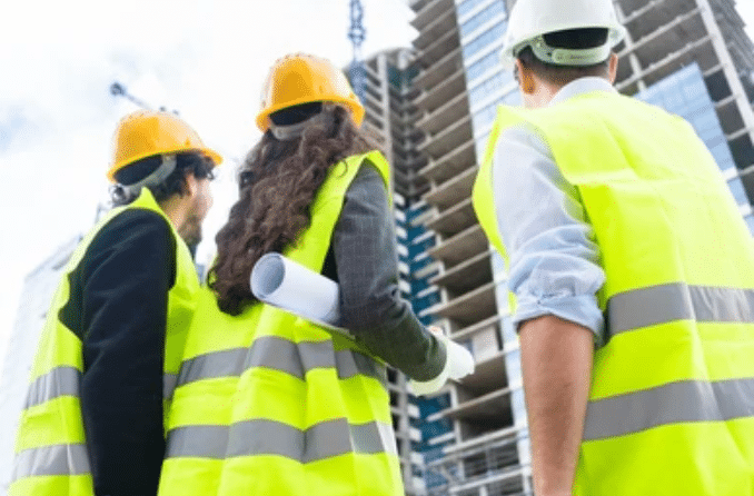 Inspection team reviewing progrress at high rise construction site.  